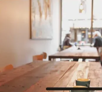 Quiet café with sunlit wooden table